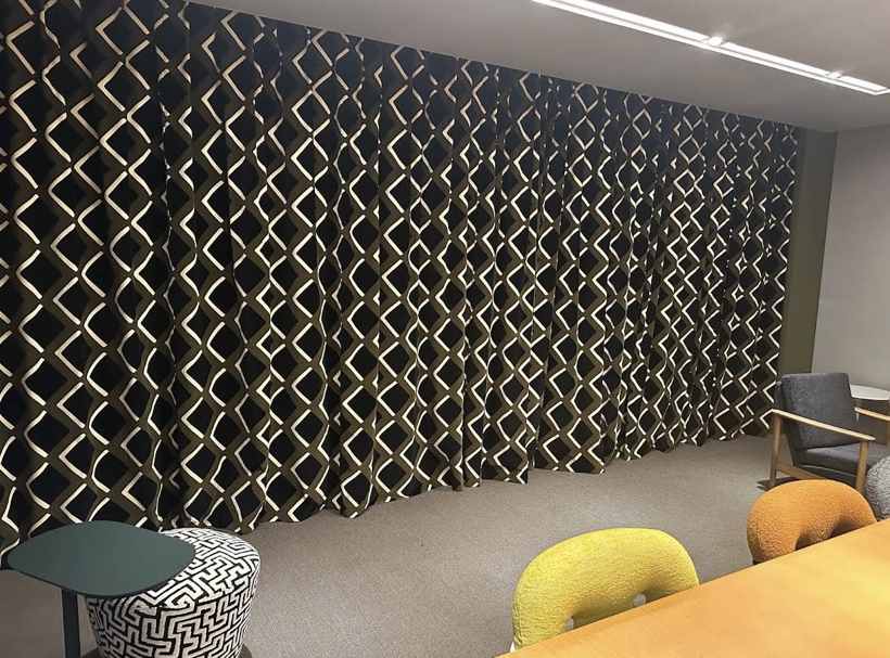 Full-wall geometric drapery in a commercial meeting room